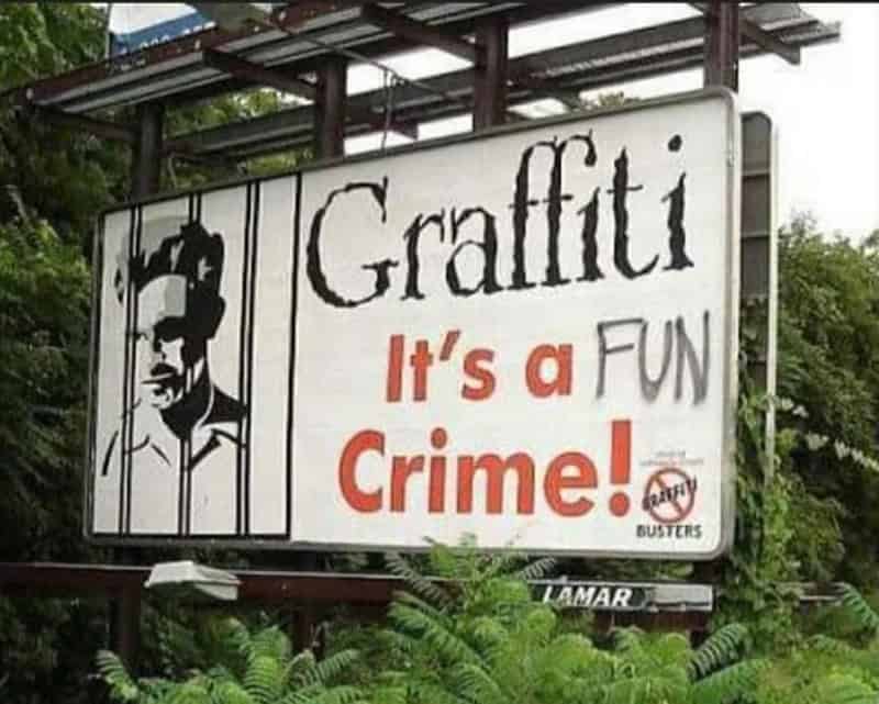 Graffiti sign with a drawing of a man and the text "Graffiti It's a FUN Crime!".