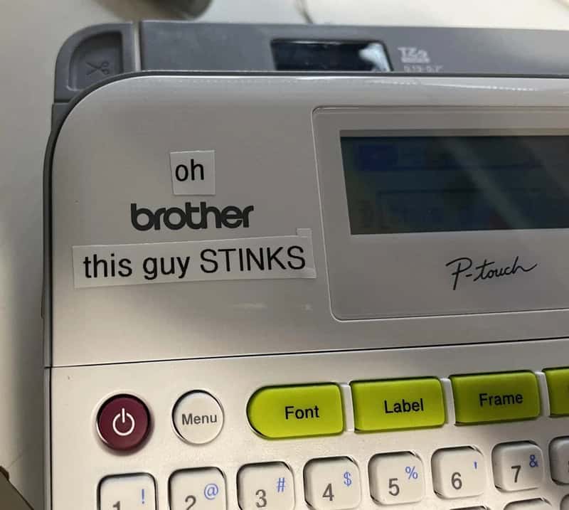Sticker on Brother P-touch label maker says 'oh this guy STINKS'.