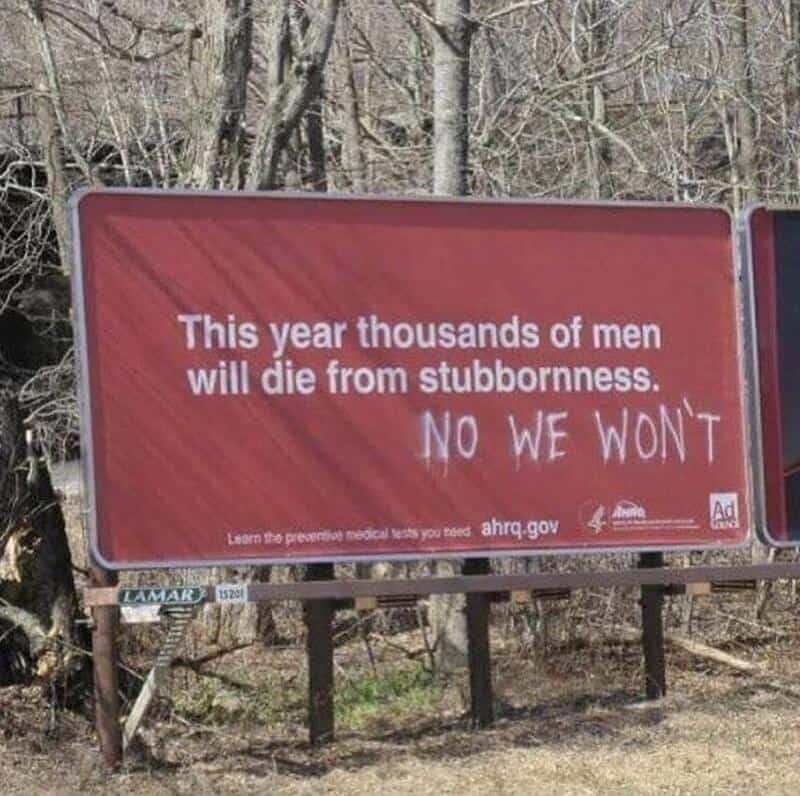 Billboard with a message about stubbornness and a graffiti addition saying 'NO WE WON'T'.