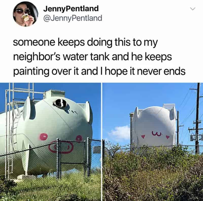 Water tanks painted with cute faces, one with a pink smile and the other with a pink w and hearts.