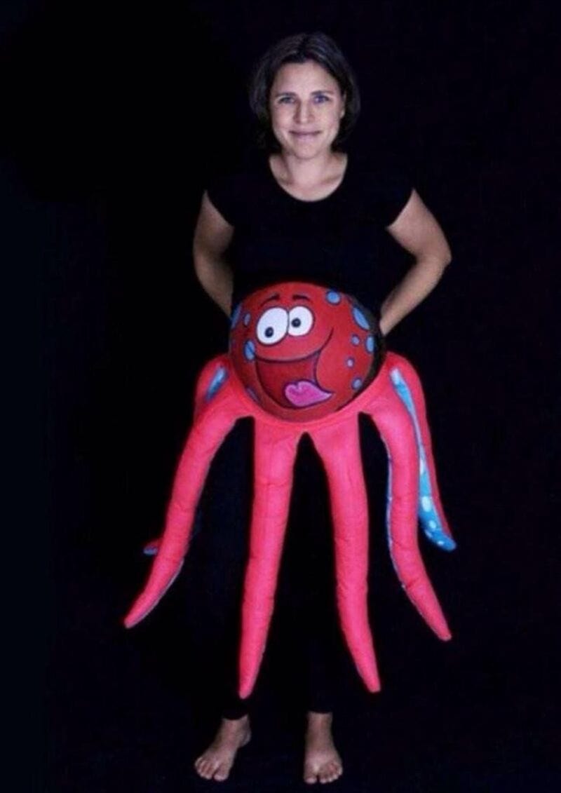 Woman in black shirt with octopus costume from '35 Funny Pregnancy Halloween Costumes That Put The B.
