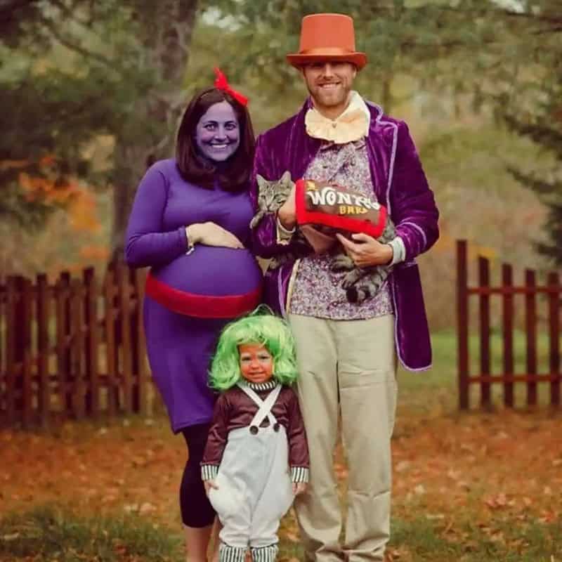 Family dressed as characters from Willy Wonka, with a pregnant woman as Violet Beauregarde.