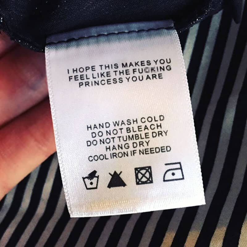 Clothing care label with humorous message and care instructions.