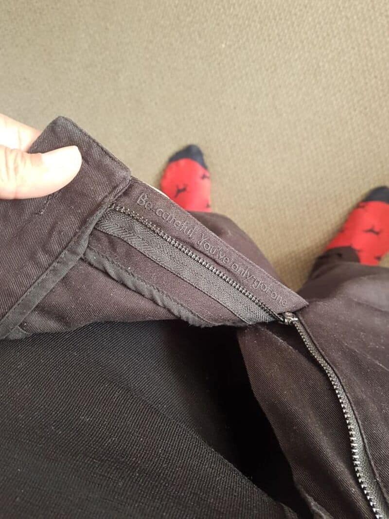 Close-up of a zipper with a hidden message inside the jacket.