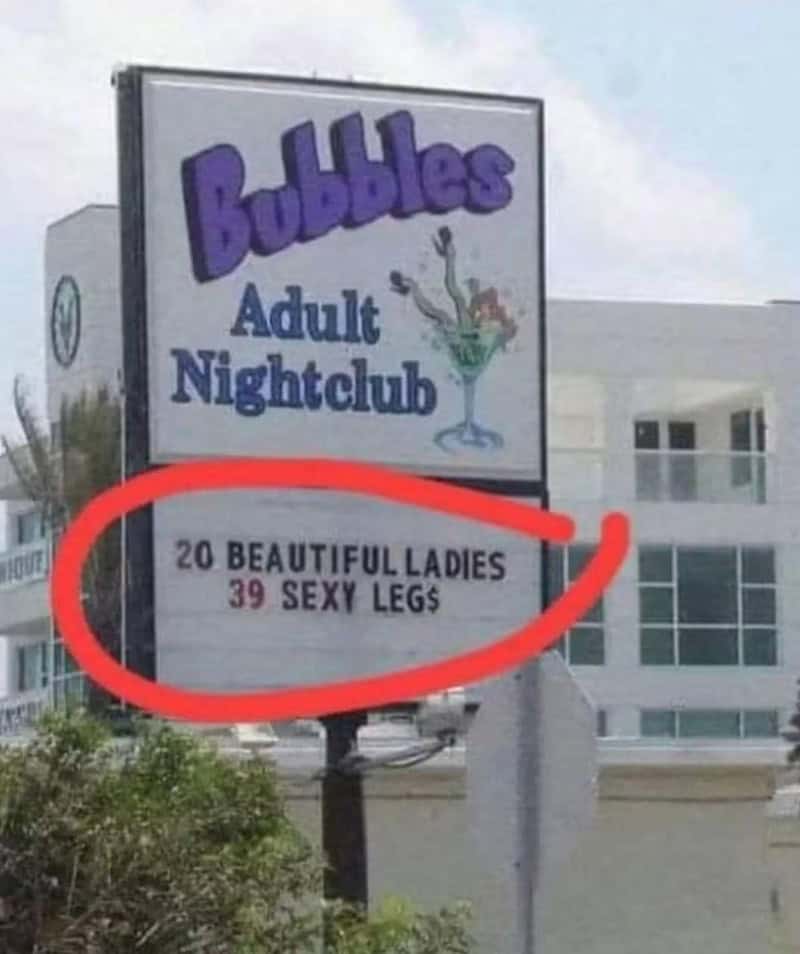 Bubbles Adult Nightclub sign with circled text reading '20 BEAUTIFUL LADIES 39 SEXY LEGS'.