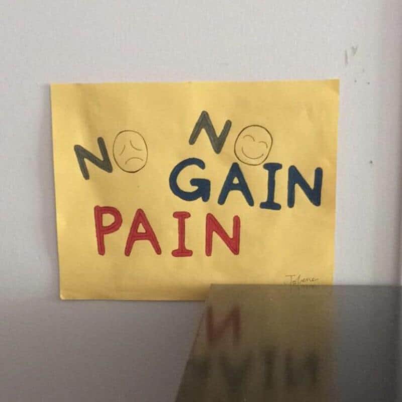 No gain, no pain poster on a wall with smiley faces within N letters.