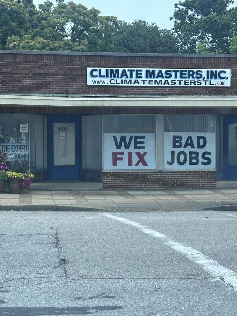 Climate Masters, Inc. storefront with large window signs reading WE FIX and BAD JOBS along a street.