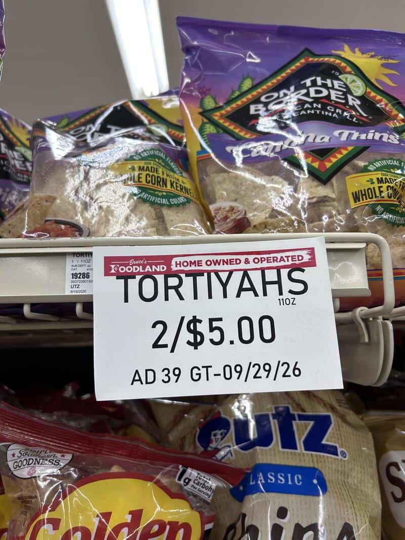 TORTIYAHS 2/$5.00 sign on store shelf with snack bags in background.