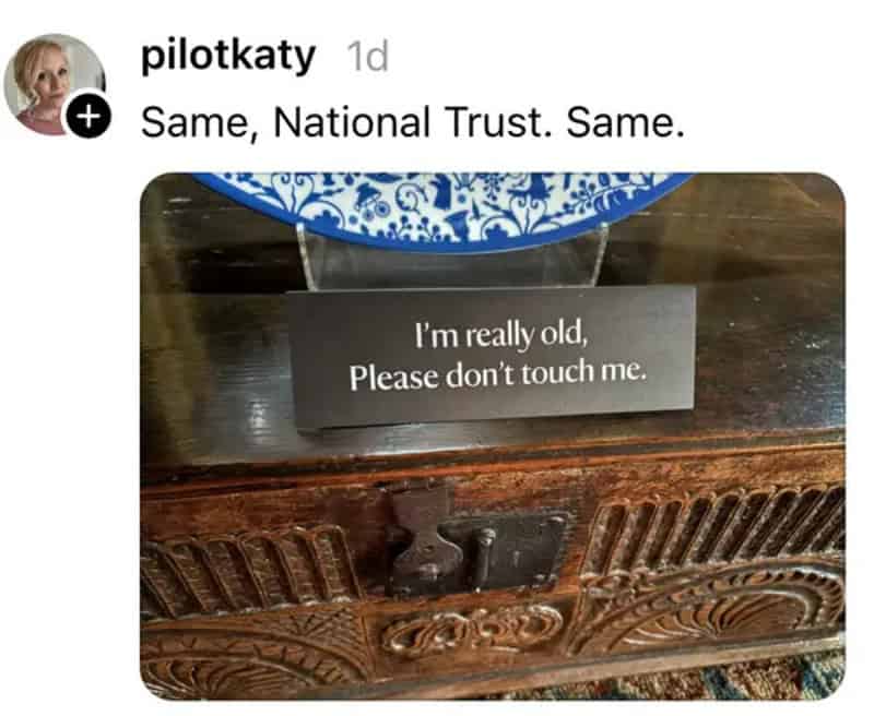 Sign on wooden furniture reads "I'm really old, Please don't touch me.".