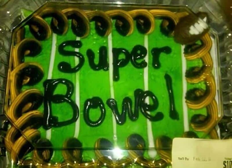Super Bowl cake with green icing and black lettering reading 'Super Bowl' and bordered with pretzels.