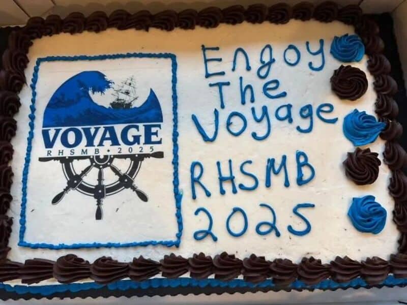 Horizon cake with voyage theme, displays logo with ship wheel and text Enjoy The Voyage RHSMB 2025.