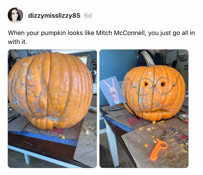 Giant pumpkin carved with glasses, resembling Mitch McConnell, on a table with carving tools nearby.
