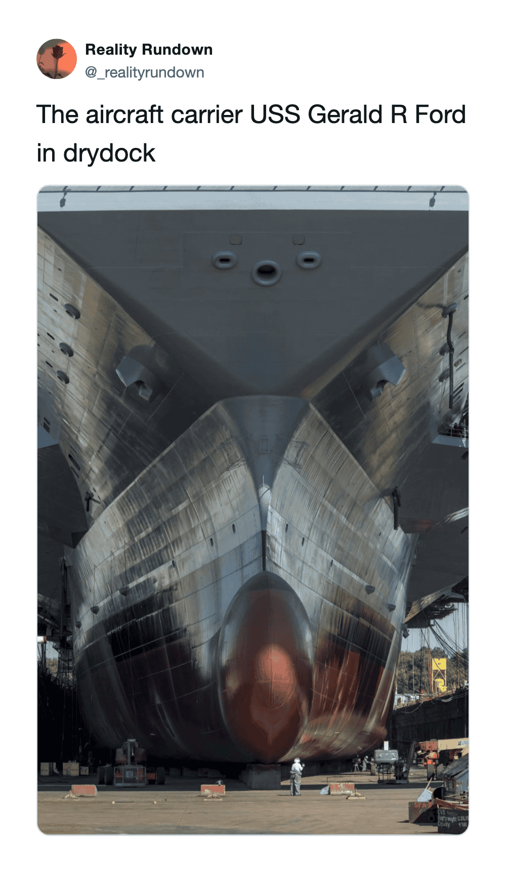 Aircraft carrier USS Gerald R Ford in drydock, viewed from front.