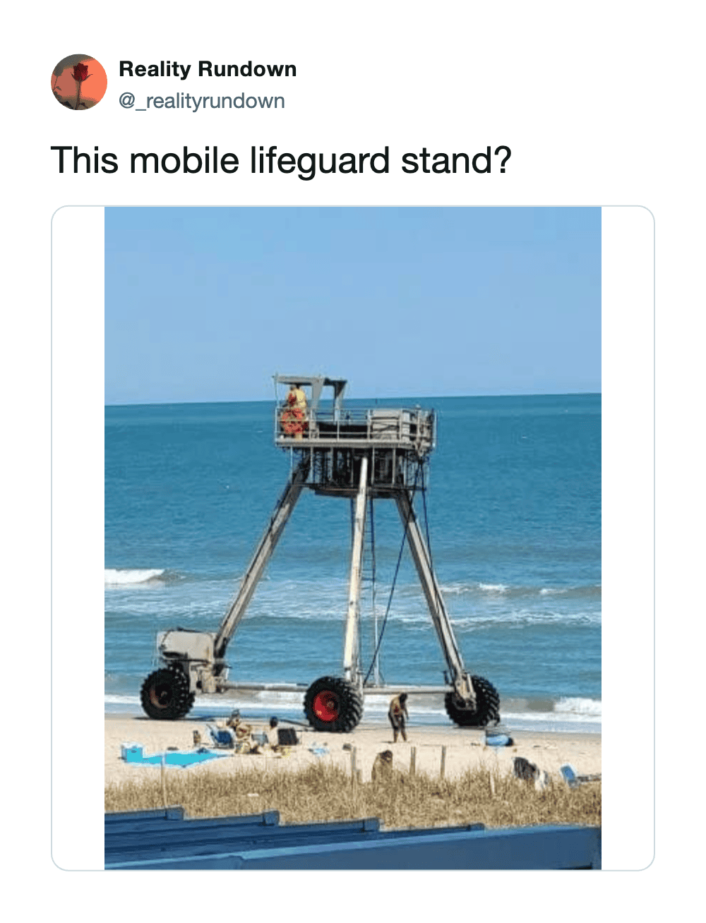 Mobile lifeguard stand on wheels at the beach with people nearby.