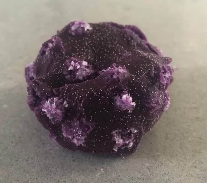 Close-up of a purple, textured, irregularly shaped mineral or rock.