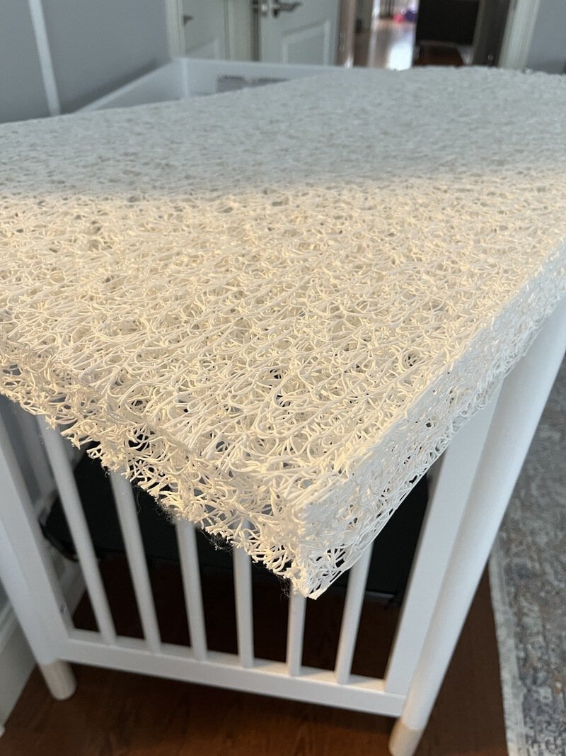 Close-up of a textured, beige, 3D-printed table surface with intricate loops.