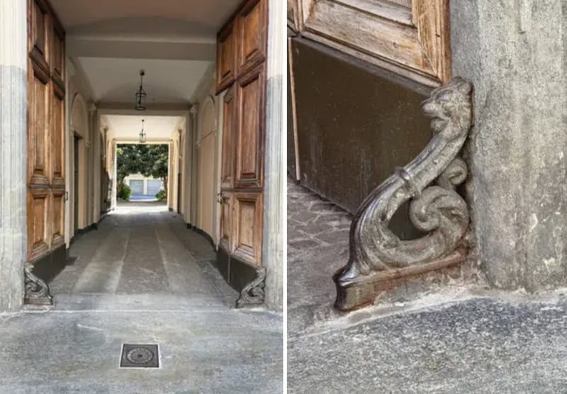 Entrance hallway with wooden doors and a view outside, ornate stone details at the base.