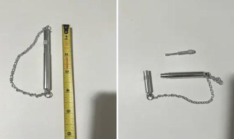 Small metallic object with chain and a separate tiny piece, on a white background.