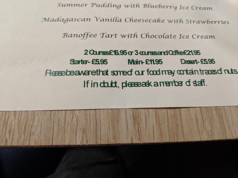 Menu with desserts and prices, some text is blurry and difficult to read.