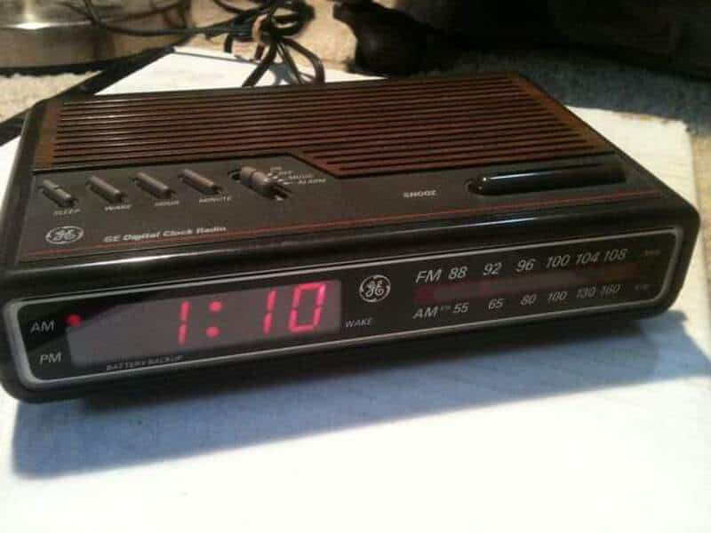 Nostalgic GE digital clock radio with AM/FM dials and red LED time display reading 1:10, brown wood‑.