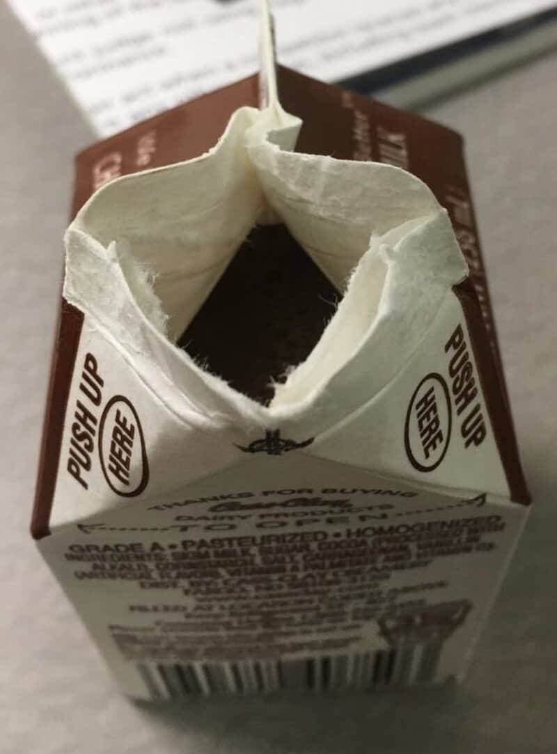 Nostalgic carton image of a small open milk carton with torn top and visible nutrition block.