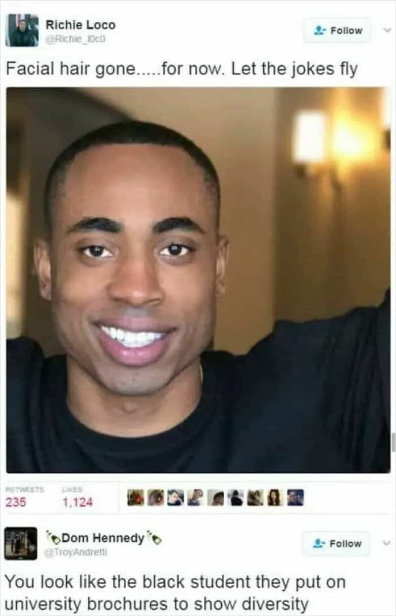 Close-up of a smiling man with a shaved head, no facial hair, and a black shirt.