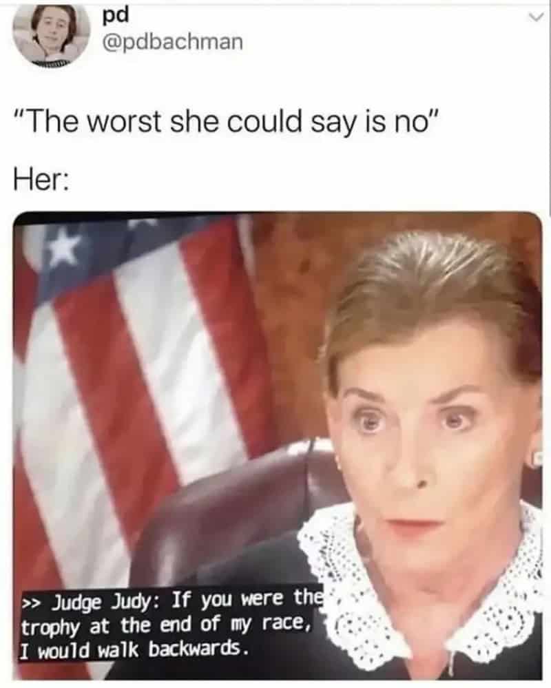 Judge Judy with an American flag in the background, saying she would walk backwards for a trophy.