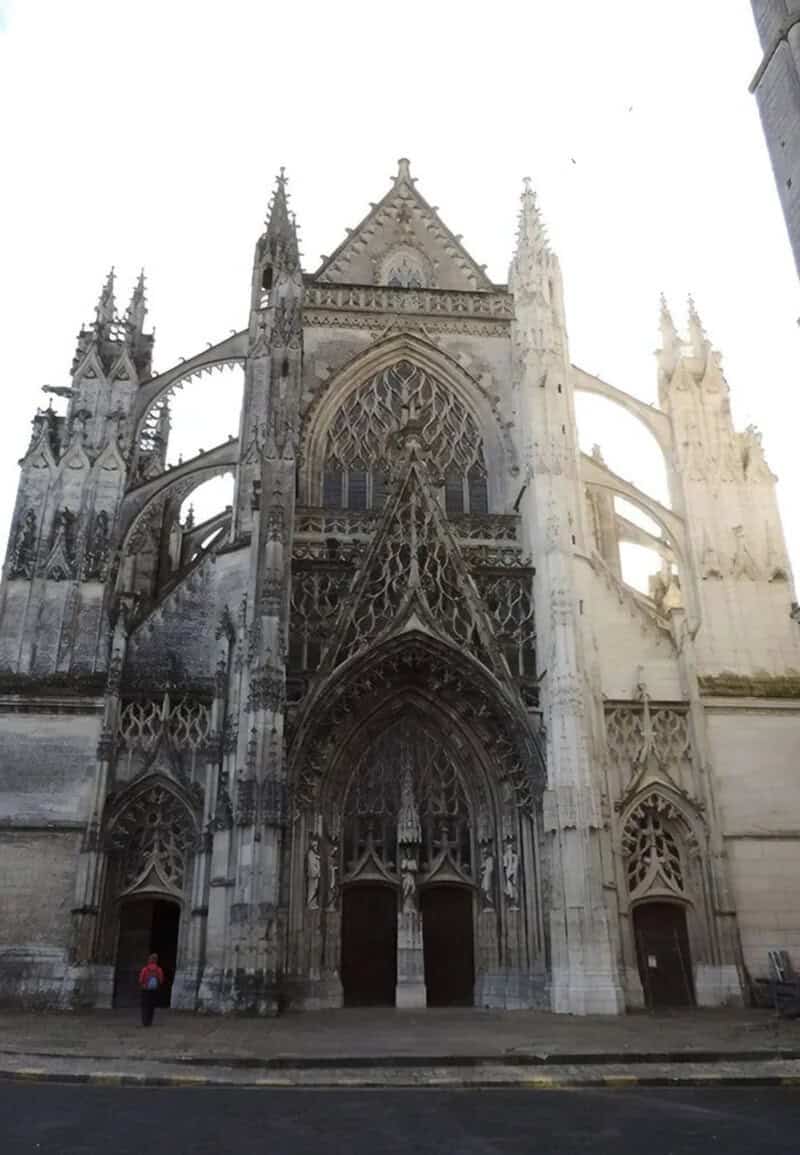 Gothic cathedral with intricate stone carvings and tall spires, viewed from the front.
