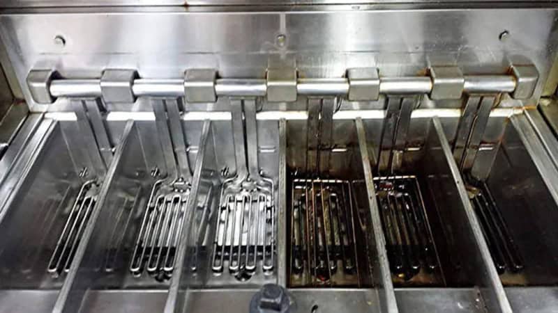 Power washing cleaning grill grates, showing before and after results.