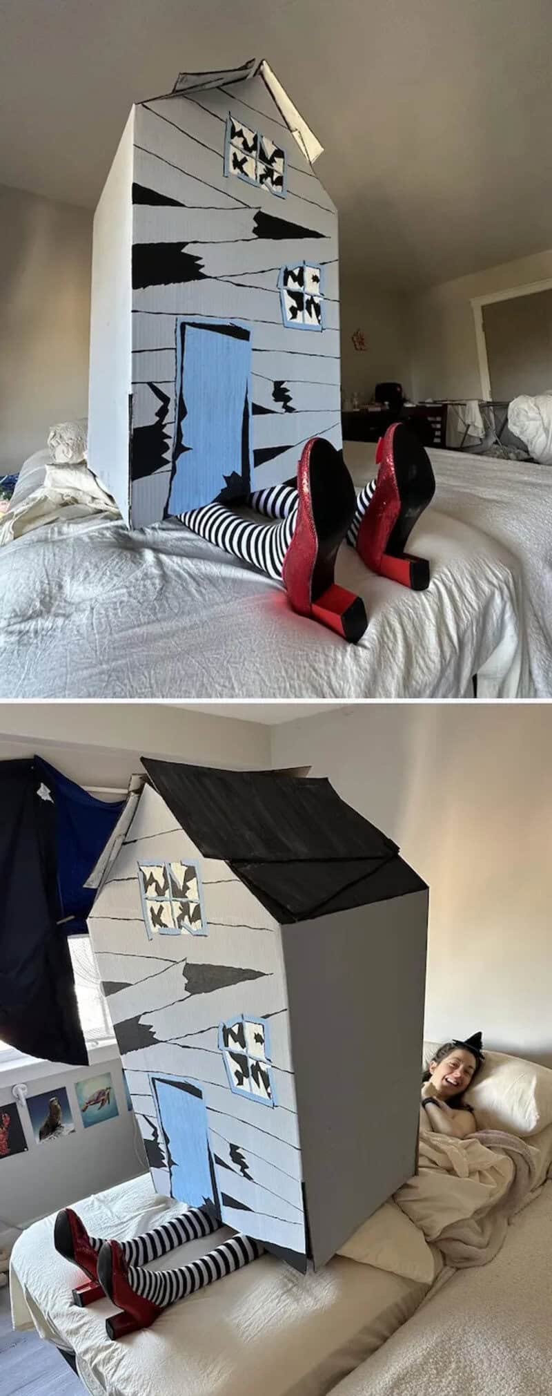 A person wearing striped pants and red shoes lies beside a gray painted cardboard haunted house prop.