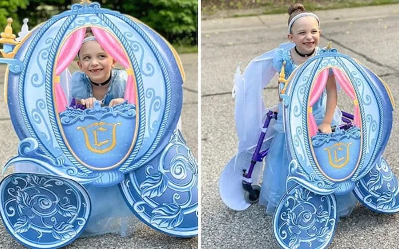 Girl wearing a blue Cinderella carriage costume for Halloween.