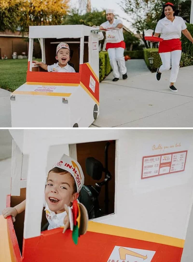 Child in a homemade cardboard car costume; others in costumes push the vehicle in a parade.