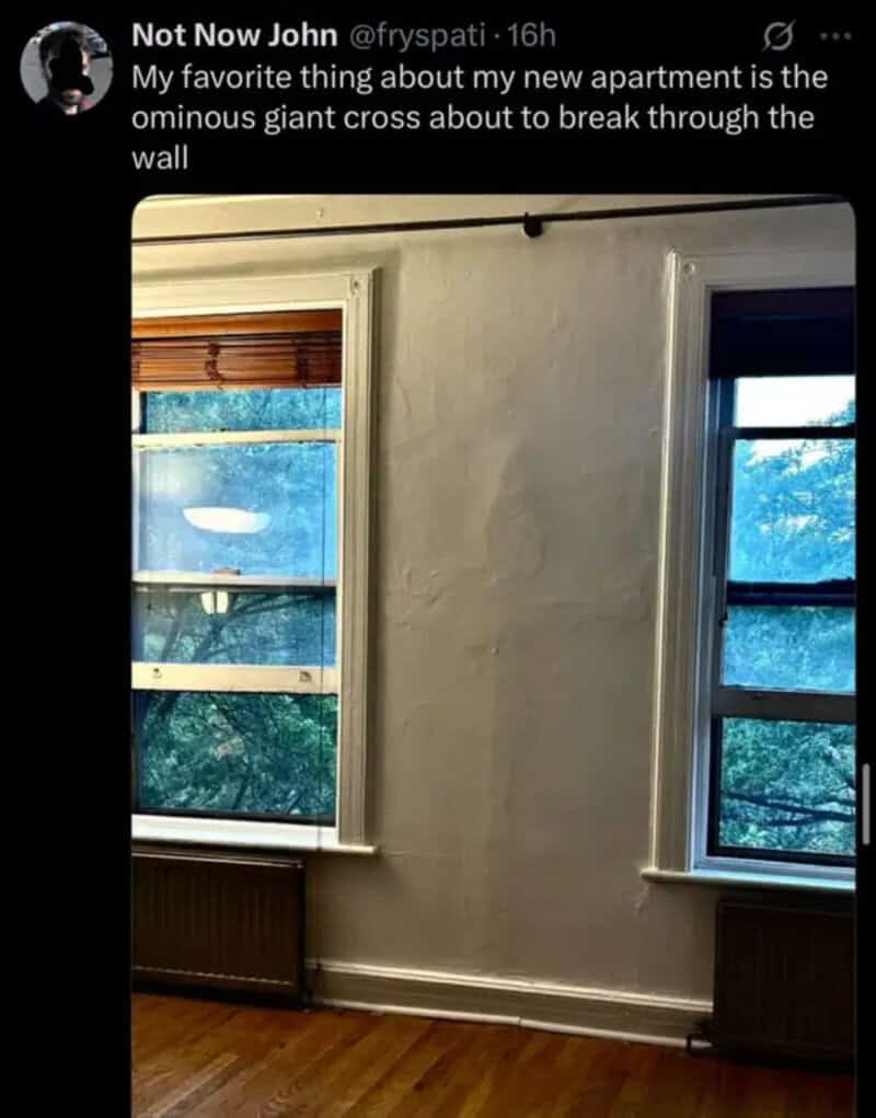 Not Now John tweet image: a room with two windows, bare walls and wooden floor.