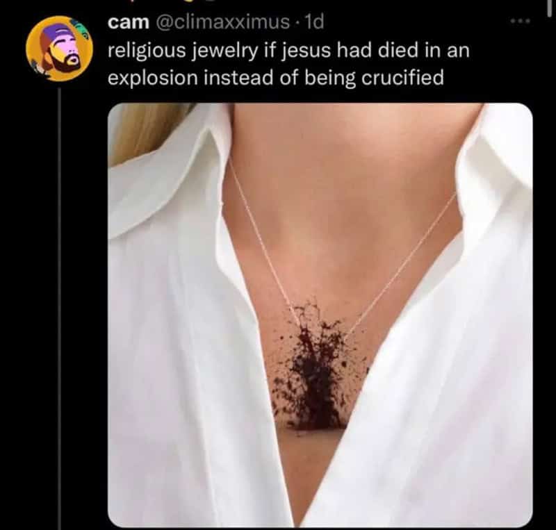 Religious jewelry necklace with a dark chest tattoo design resembling a cross-shaped stain beneath a.