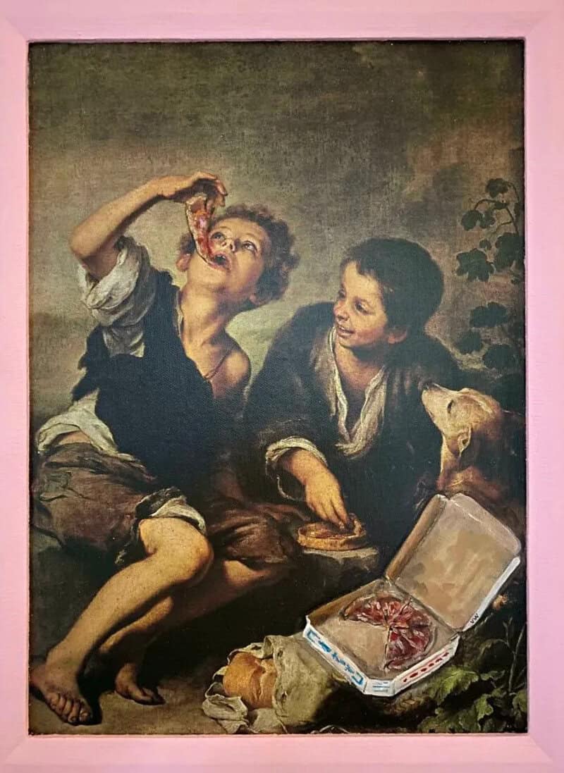 Two children, one eating pizza, the other with a dog, in front of a pink wall.