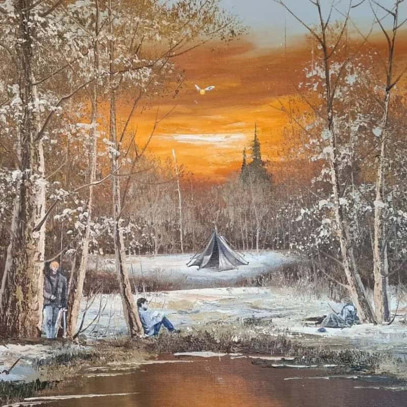 Sunset over a winter forest with a tent and people by a river.