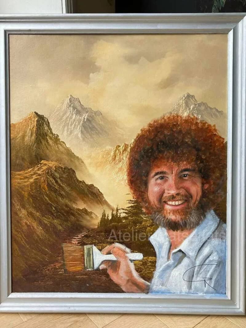 Painting of a man with curly hair holding a paintbrush, mountain landscape background.