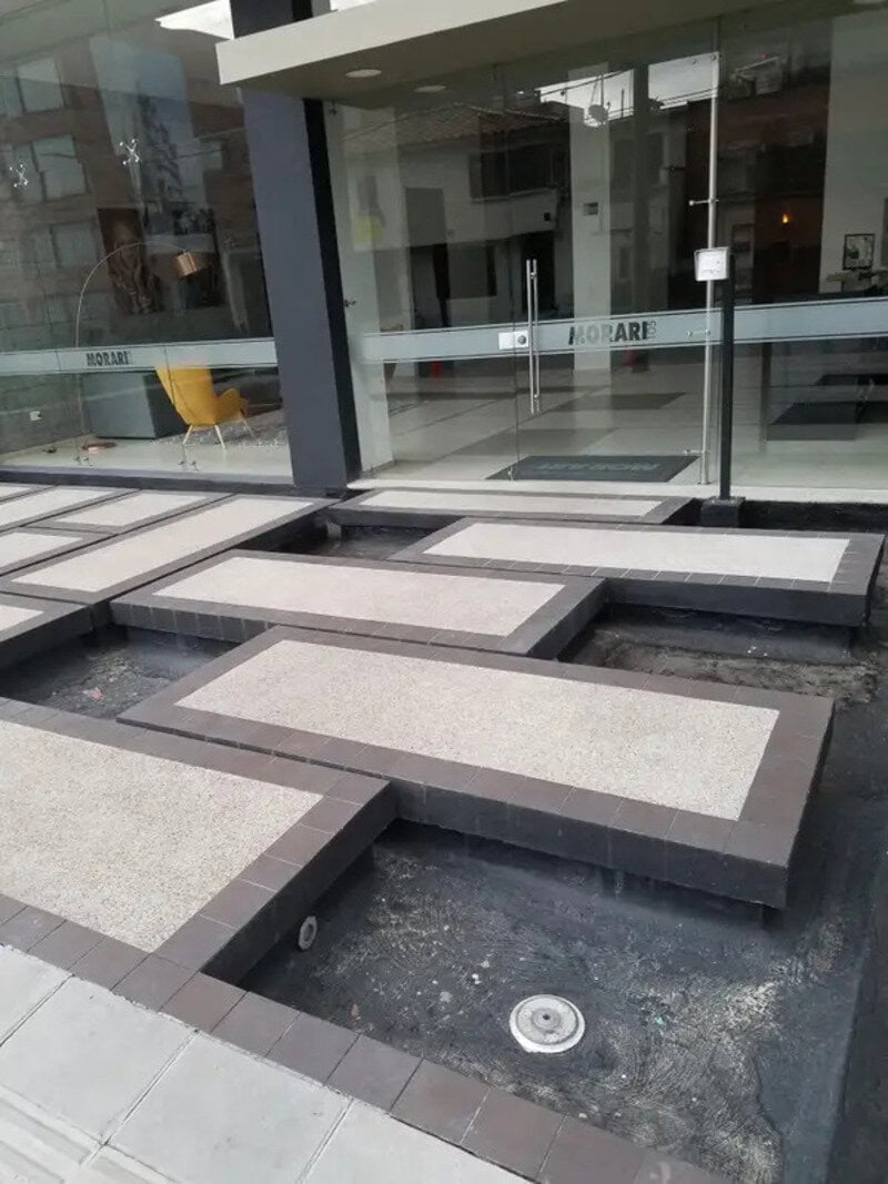 Uneven and poorly designed outdoor steps with gaps and missing parts.