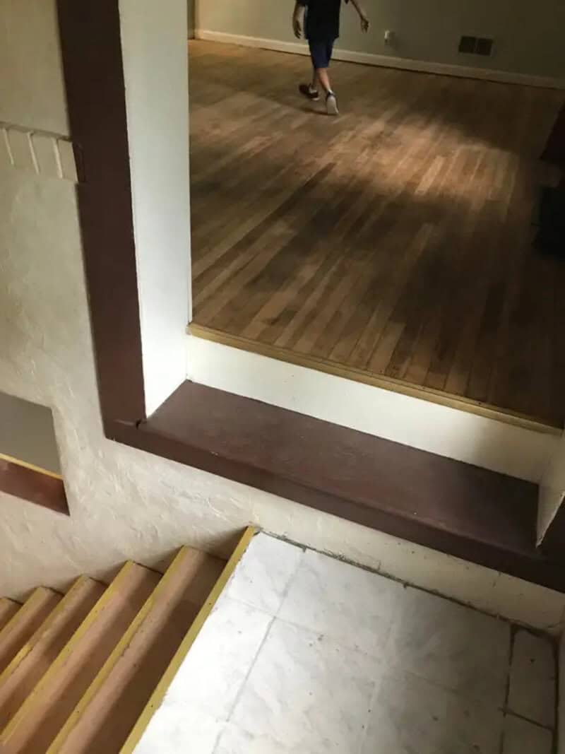 Step over threshold with uneven height and a ledge, creating a tripping hazard.