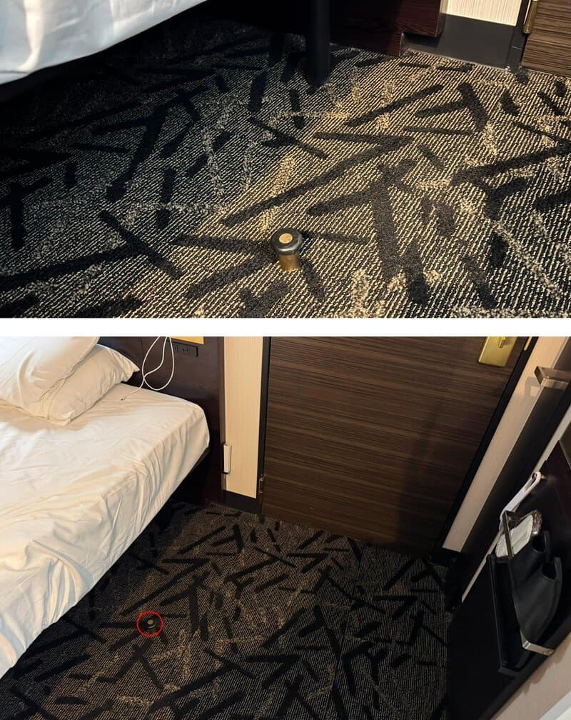 Carpet with a black and gray pattern, a small round object, and a red marker.