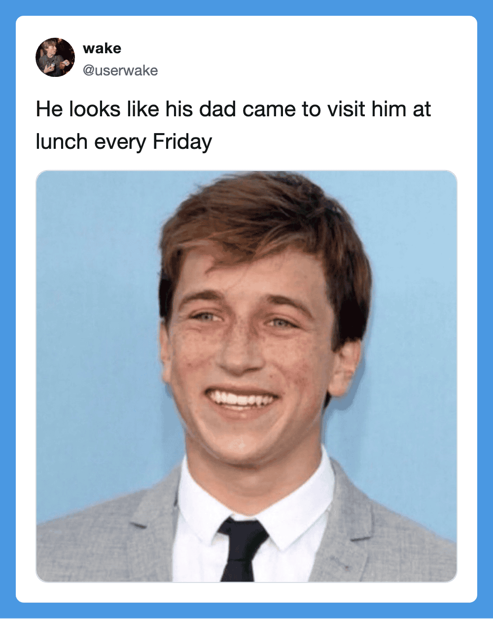 Smiling young man in a suit with a dad-like expression.