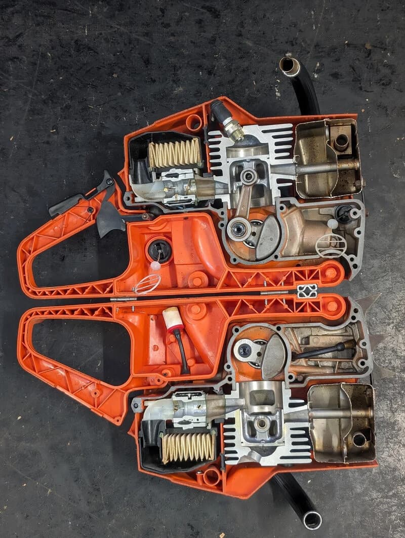 Cross-section of a chainsaw's internal components, showing gears, springs, and motor parts.