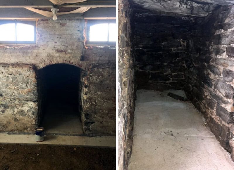 Old brick basement with small windows and a dark tunnel entrance.
