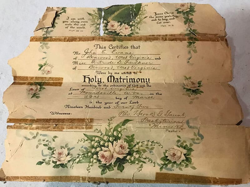 Old, torn wedding certificate with floral design, from the post 'things-found-hidden-old-houses'.