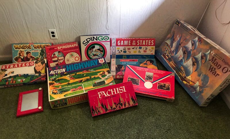 Collection of vintage board games and a puzzle on the floor.
