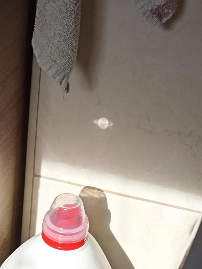 A small white object on the ceiling looks like a tiny spaceship.