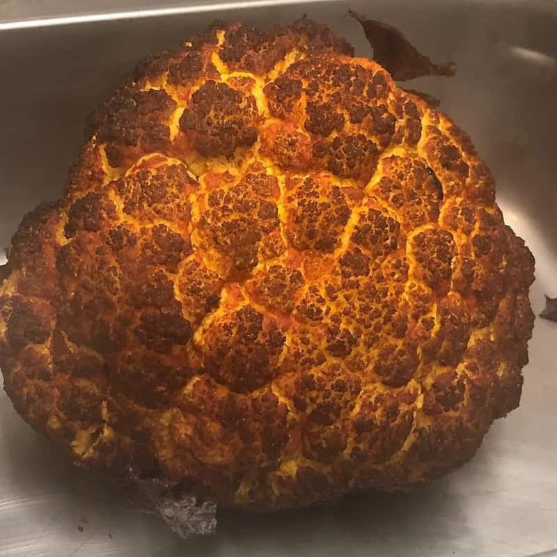 Close-up of a roasted cauliflower head with charred spots.