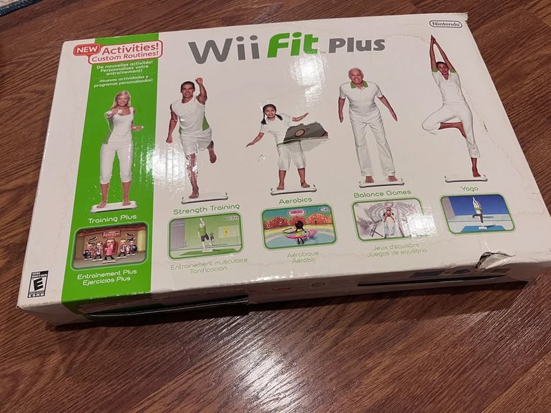 Wii Fit Plus box with images of people doing exercises and yoga.