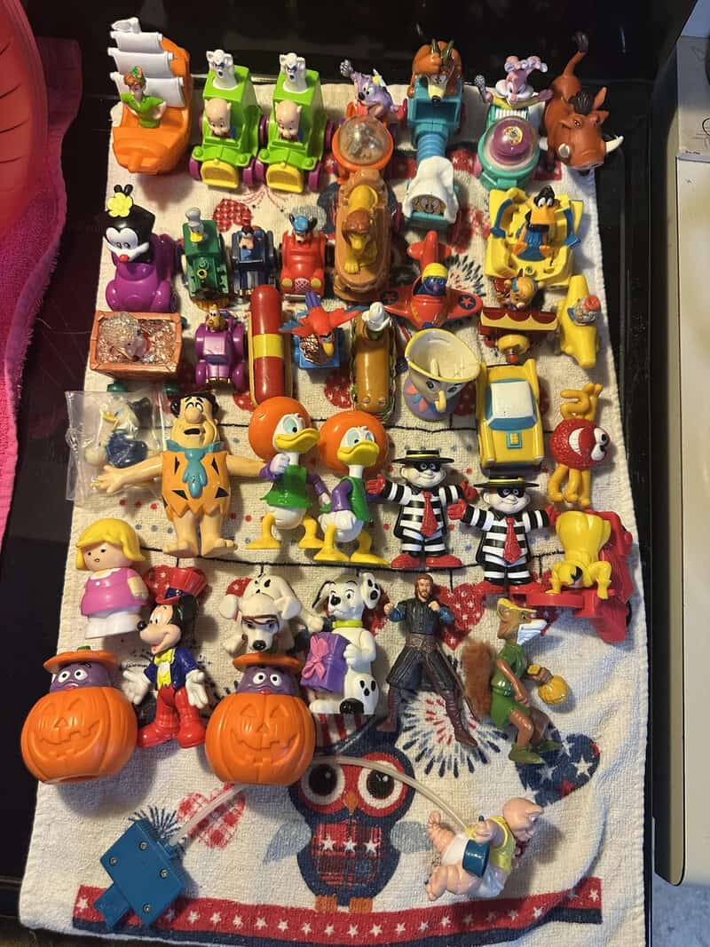 Colorful collection of toys including animals, characters, and Halloween pumpkins.