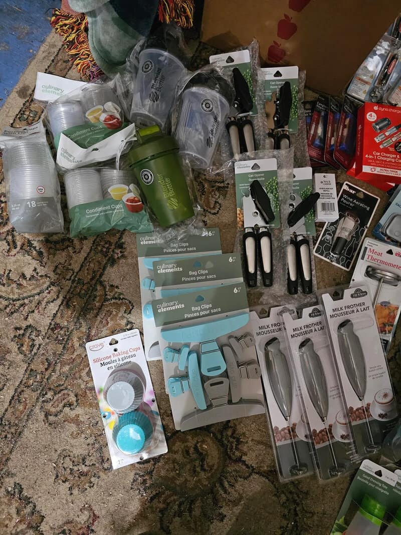 Various household items including containers, knives, and kitchen gadgets on a rug.